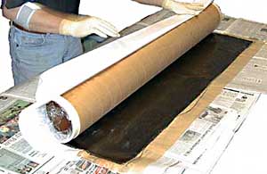 Fig 5. Rolling the carbon fiber onto the airframe tube.